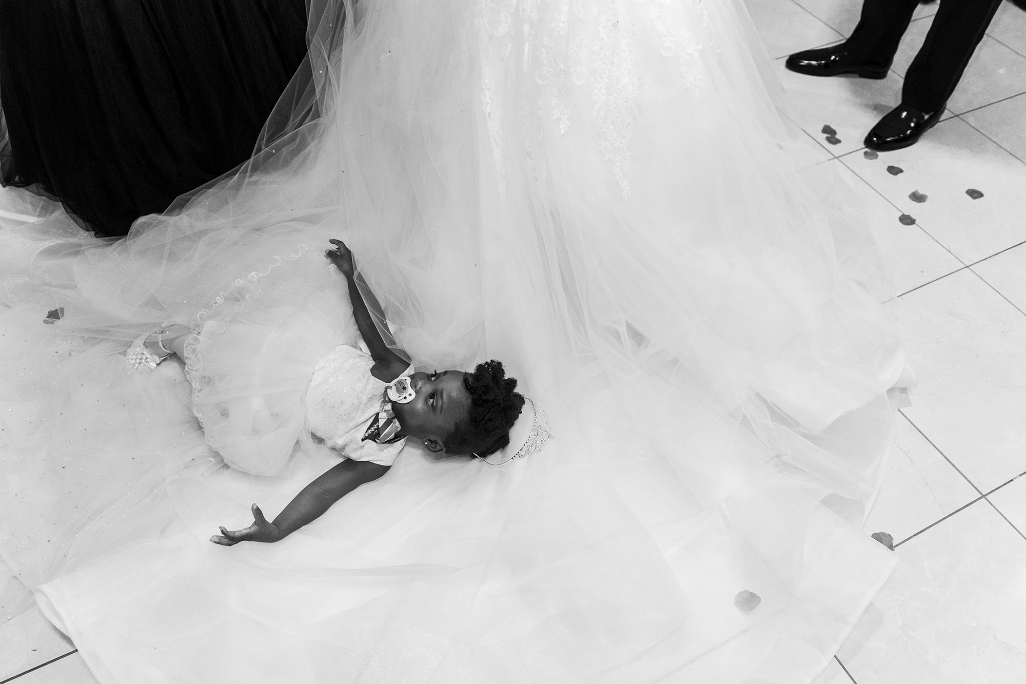 little-black-girl-laying-on-wedding-dress-greektown-square-event-center